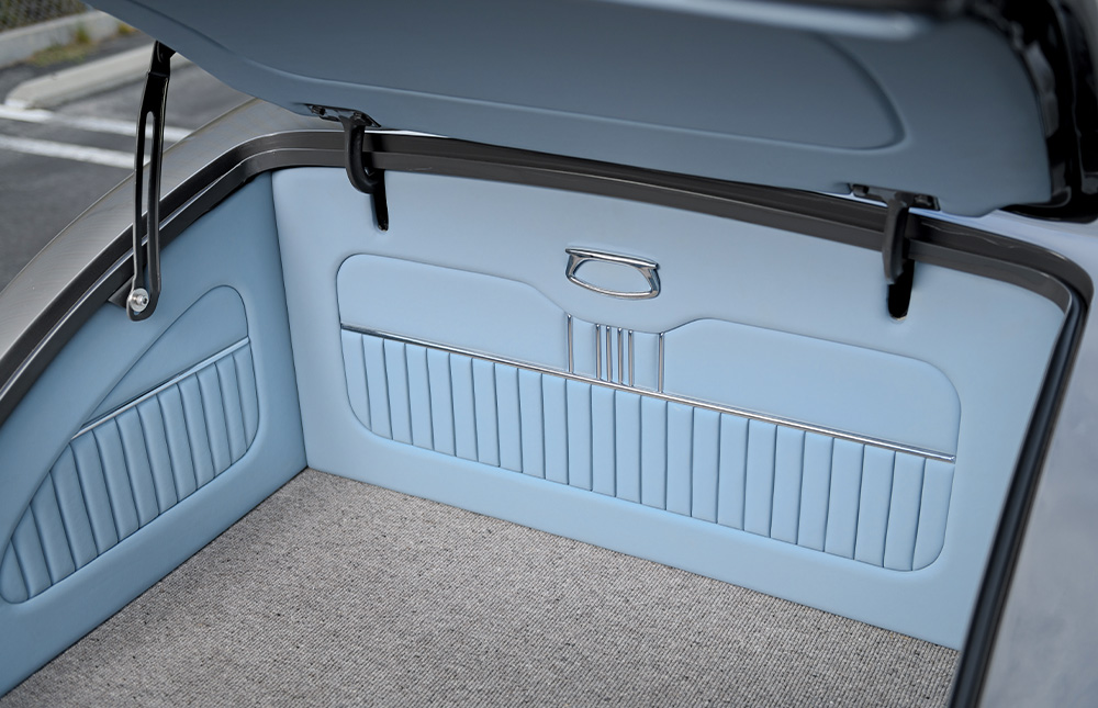 1936 Ford trunk interior light blue upholstery with ribbed paneling and carpeted finish for sleek custom look