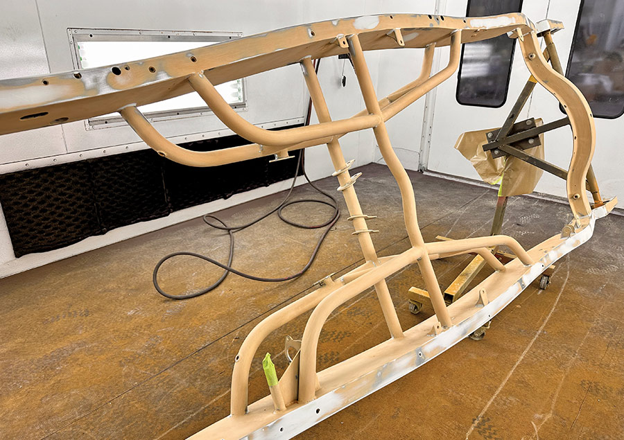 Tubular roadster chassis in primer, showcasing its intricate structure for durability and performance