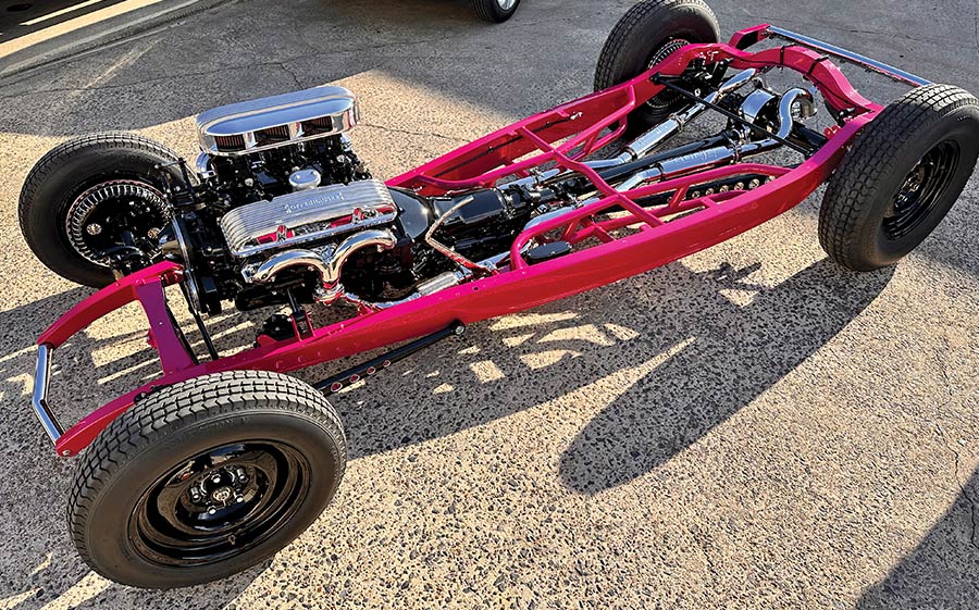 Roadster chassis painted pink with a fully assembled drivetrain and chrome components
