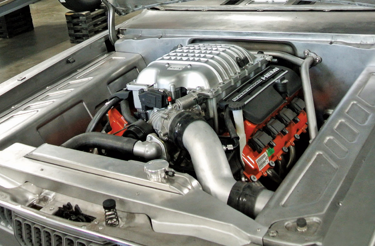 Supercharged HEMI engine under the hood of the custom 1971 Plymouth with clean fabrication