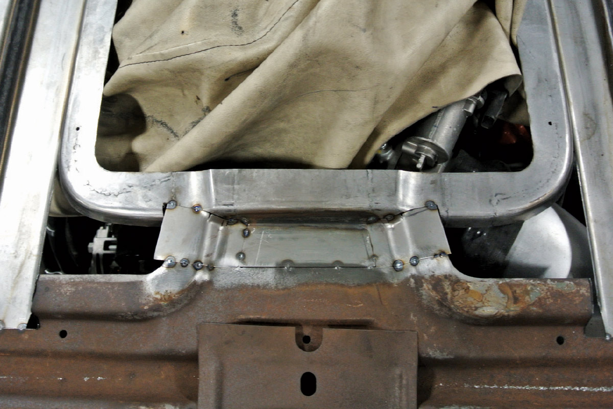 Custom weld work reinforcing the hood's lower framework with carefully aligned support pieces