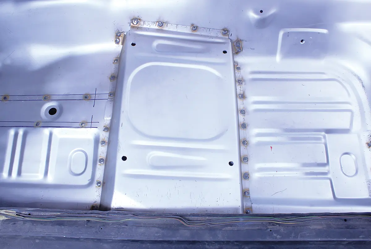 Installed seat riser panel on 1965 Ford Mustang floor pan, secured with welds