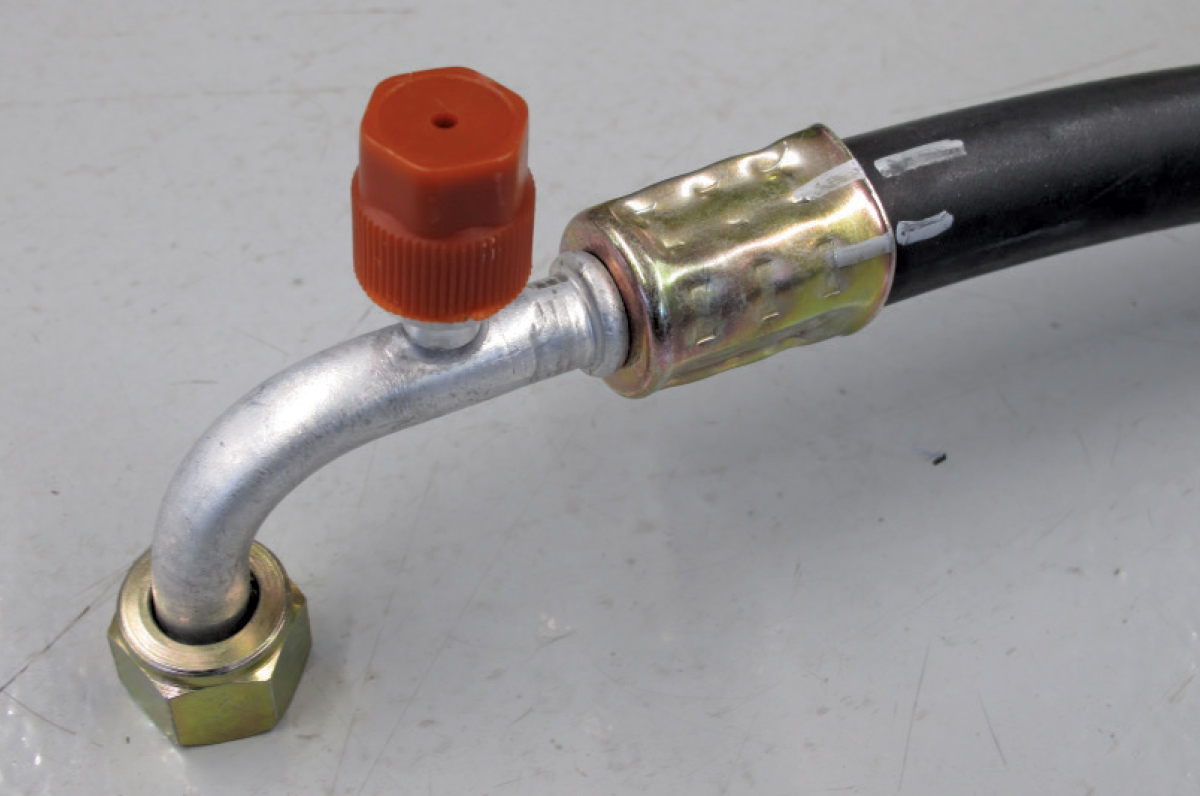 Completed beadlock fitting on an AC hose with a protective cap on the service port