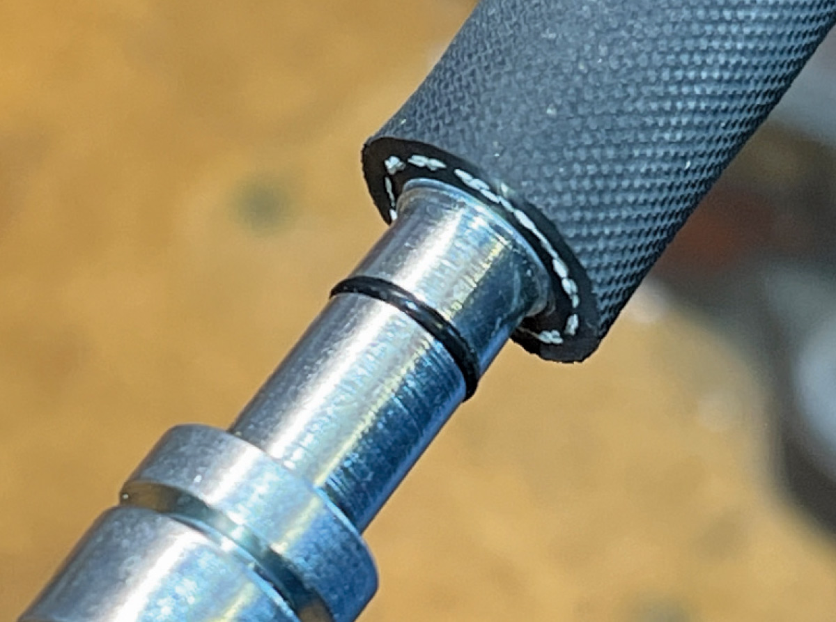 Close-up of an AC hose pushed onto a barb fitting with an O-ring for sealing