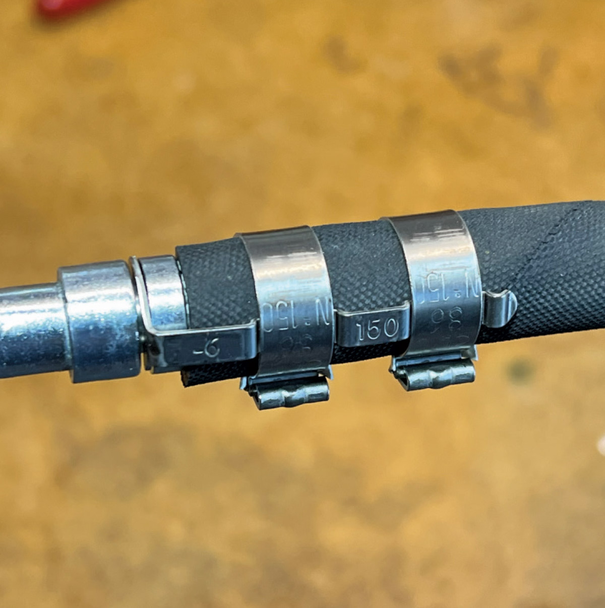 Completed hose assembly with multiple crimped clamps ensuring a secure and leak-free connection