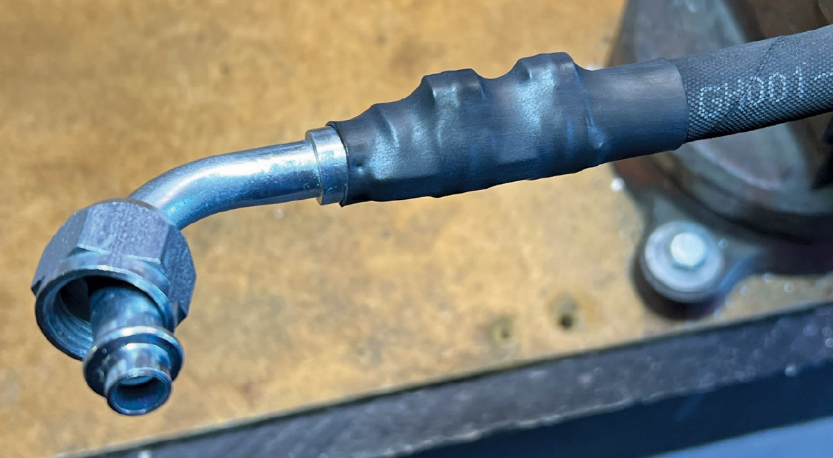 crimped AC hose with a heat-shrink cover over the fitting for additional protection