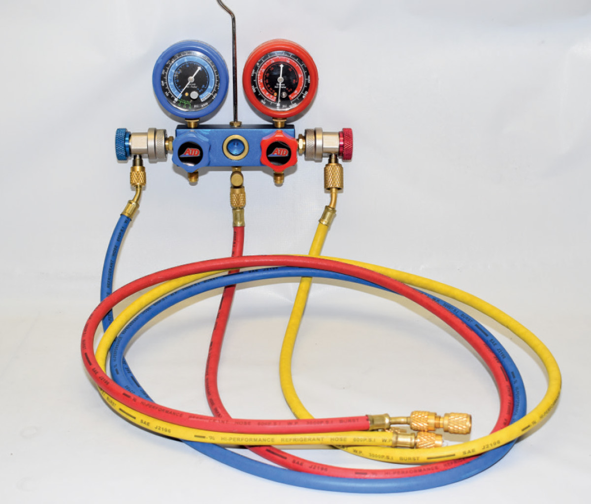 manifold gauge set with red, blue, and yellow hoses for diagnosing and servicing AC systems