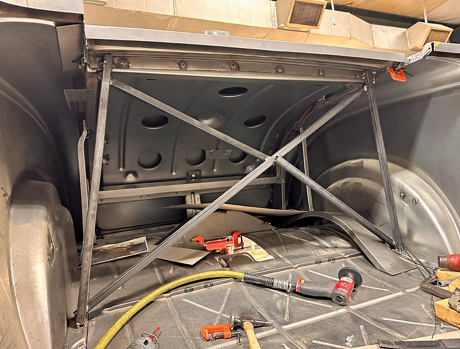 The rear chassis bracing of a 1932 Ford Roadster, featuring crossbars and metal reinforcements for rigidity