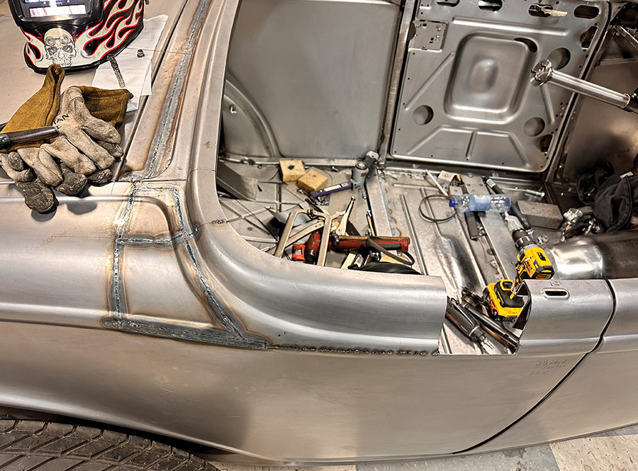 Detailed welding work shaping the custom quarter panel of a 1932 Ford Roadster