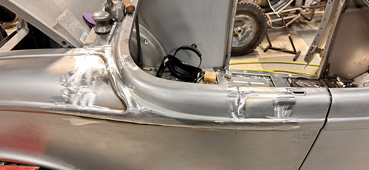 Smoothed and blended metalwork on the quarter panel of a 1932 Ford Roadster after welding and grinding