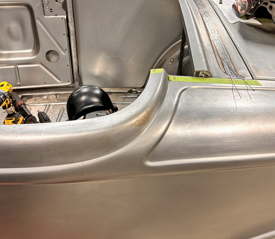 A rear deck corner of a 1932 Ford Roadster with precise metal shaping and structural reinforcement