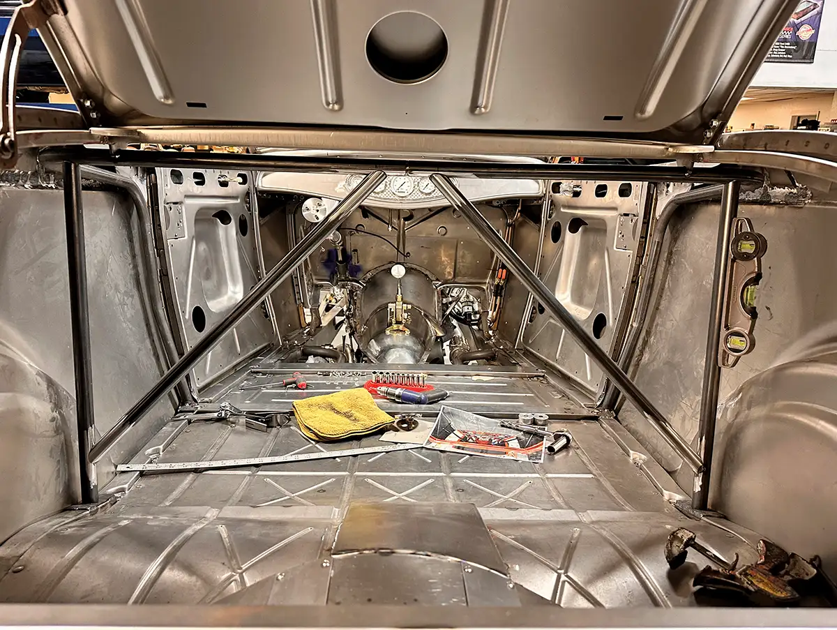 Interior view of a 1932 Ford Roadster trunk with cross-bracing and exposed sheet metal fabrication