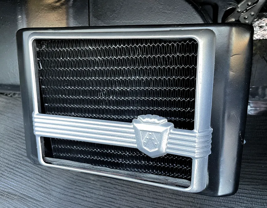1957 Ford Custom under-dash heater with a vintage grille and classic emblem