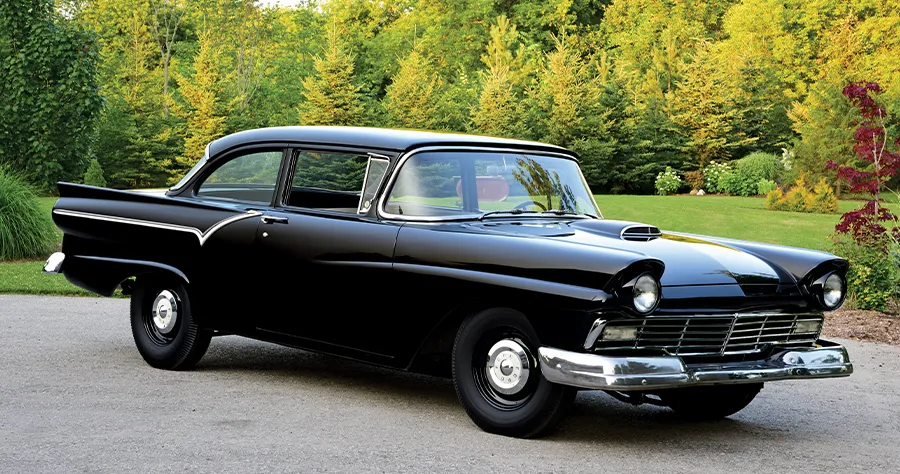 1957 Ford Custom with a blacked-out grille, hood scoop, and aggressive front-end styling