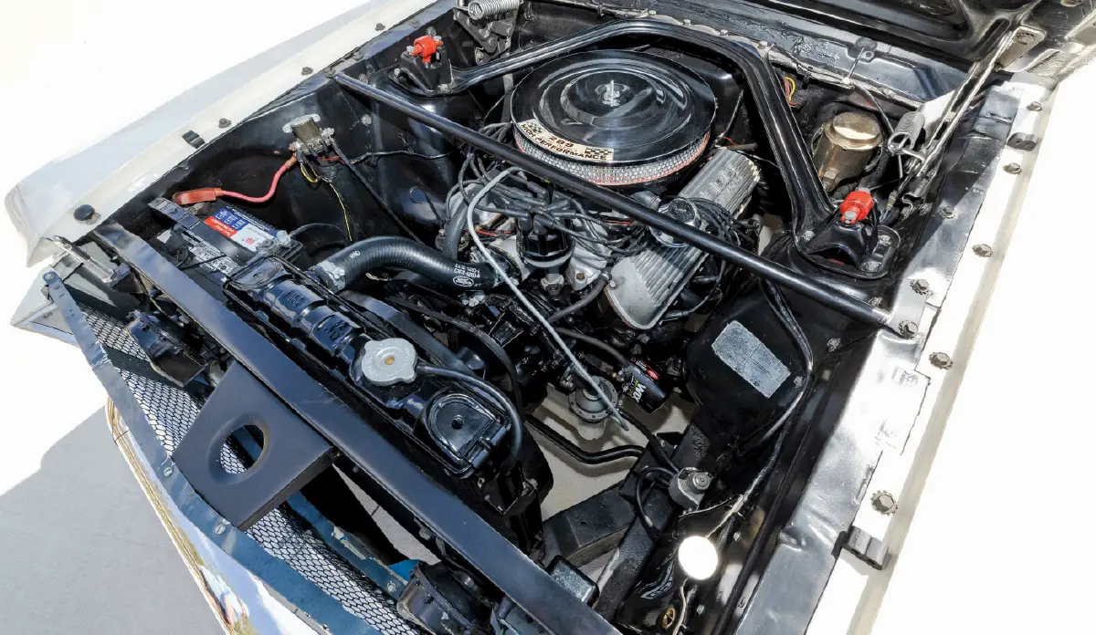 Landscape orientation close-up photograph view of the 1965 Ford Mustang Shelby G.T. 350 high-performance 289 engine block, which is marked as a K-code with 306 hp, making it one very stout factory produced small-block of its time