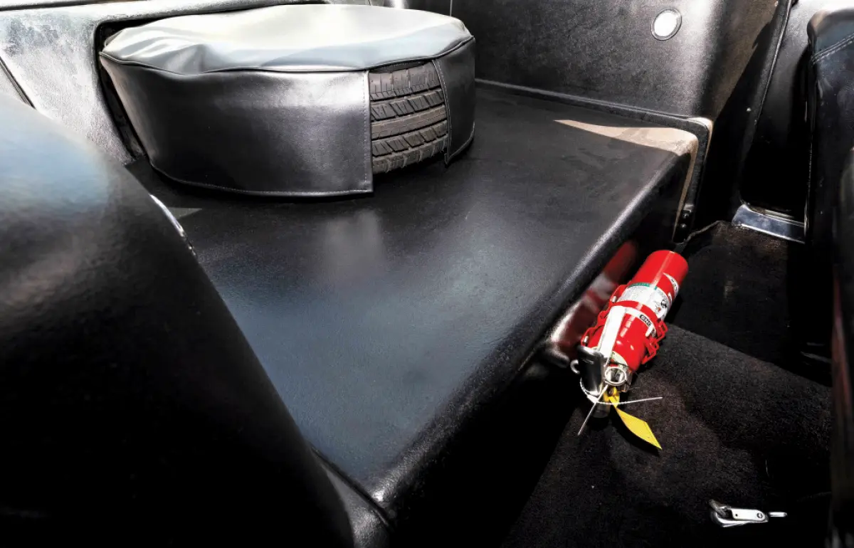 Landscape orientation photograph inside view of the Shelby G.T. 350 rear seat area, which is discarded in favor of a new rear tire mount location