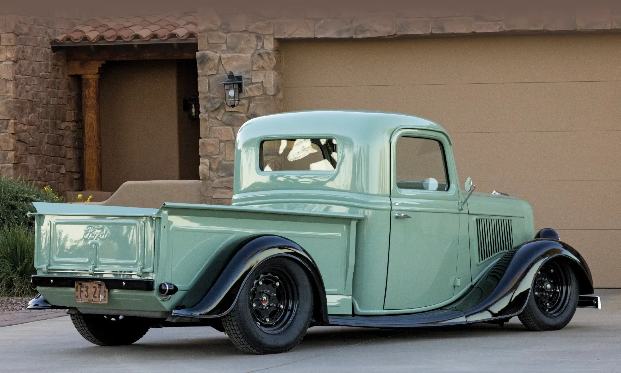 3/4 rear view of sage green 1936 ford pickup truck