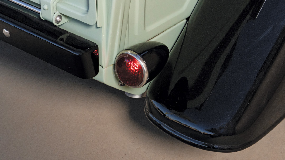 closeup of taillight on sage green 1936 ford pickup truck