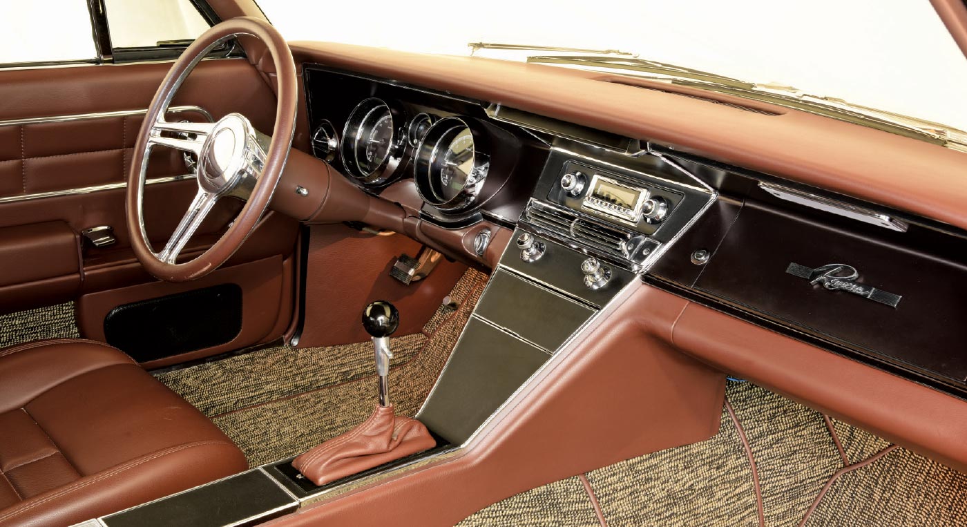 1963 Buick Riviera interior with brown leather, a chrome-accented dash, and a classic-style radio