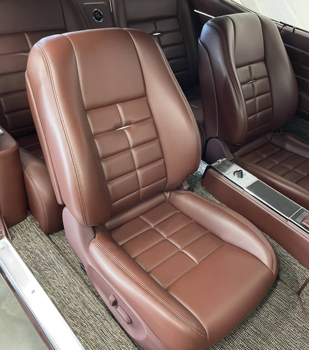 1963 Buick Riviera front bucket seats with plush brown leather upholstery and custom stitching