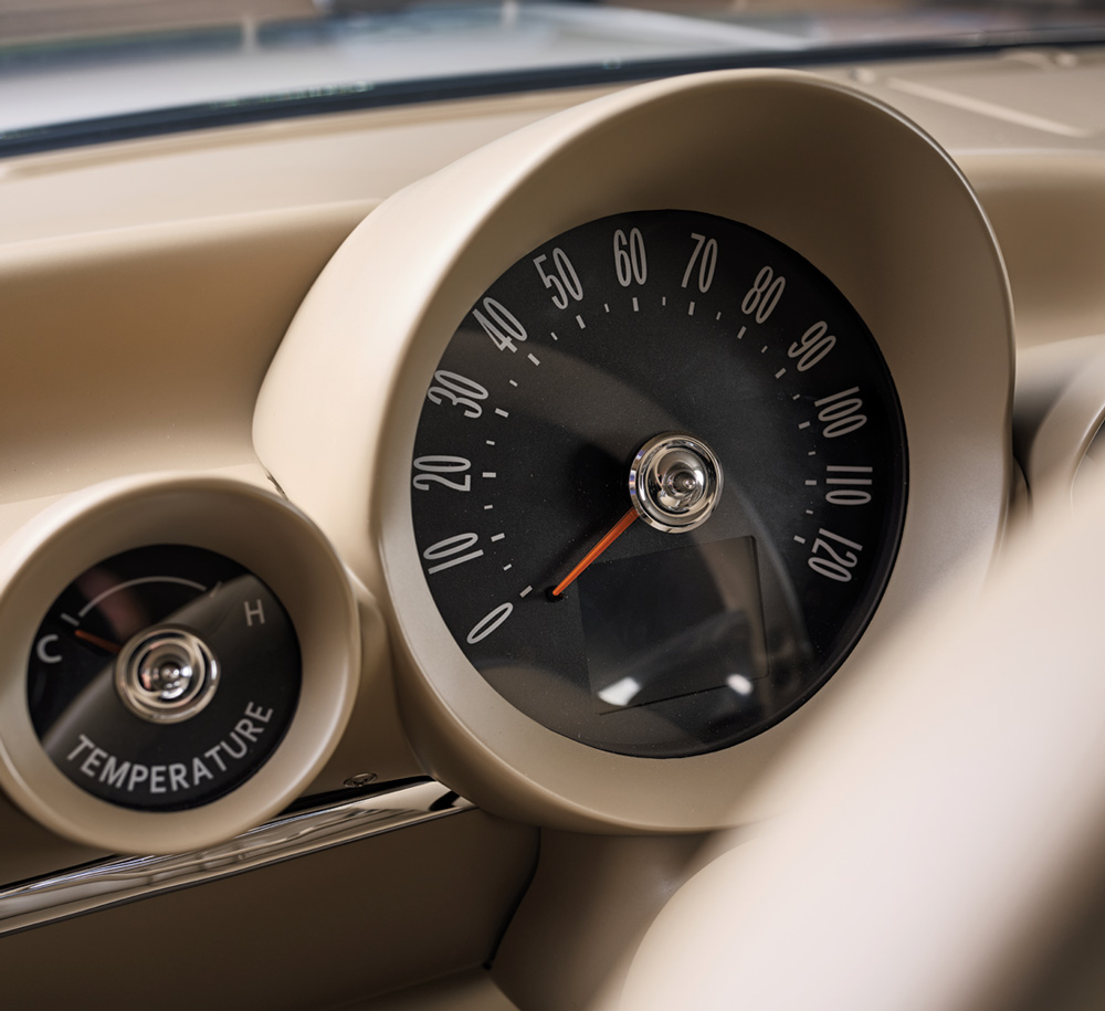 Close-up of 1959 Impala's custom speedometer and temperature gauge with classic styling and modern finish