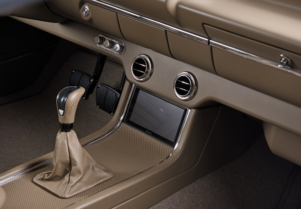 Detailed shot of center console with touchscreen, billet knobs, and modern shifter in 1959 Impala