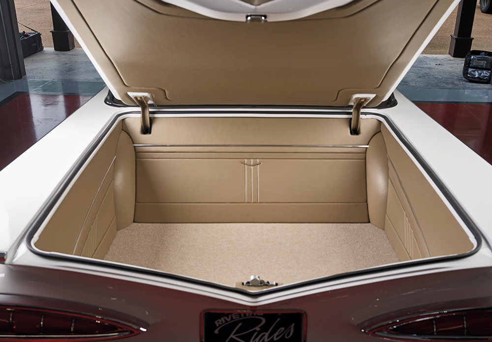 Trunk view of 1959 Impala fully upholstered in tan leather with custom paneling
