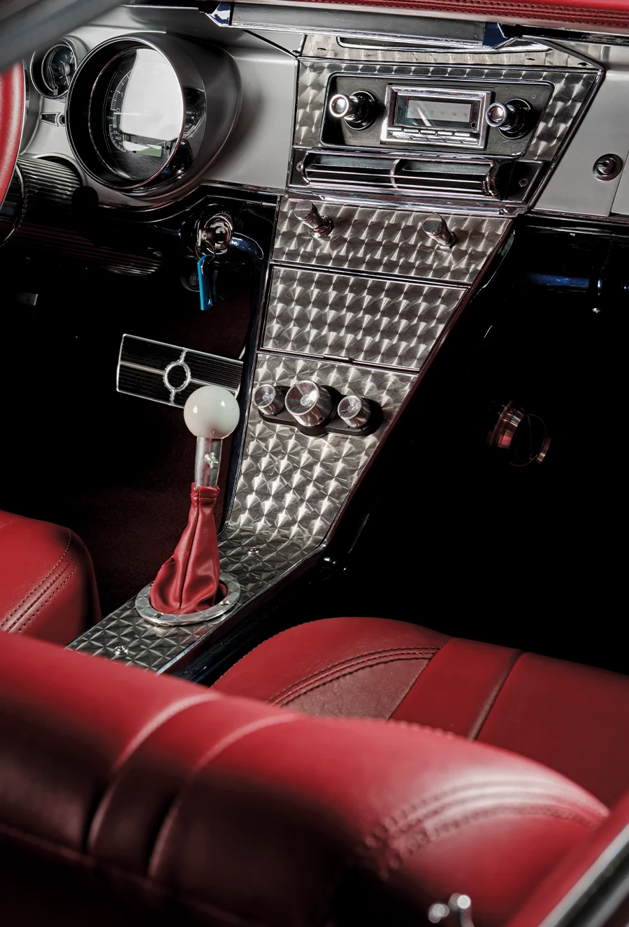 Riviera 1963 dashboard, engine-turned aluminum finish, white shift knob, vintage stereo head unit