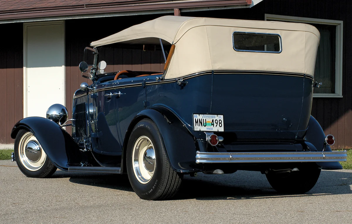 1932 Ford Phaeton in dark blue with cream top and steel wheels, a classic touring configuration