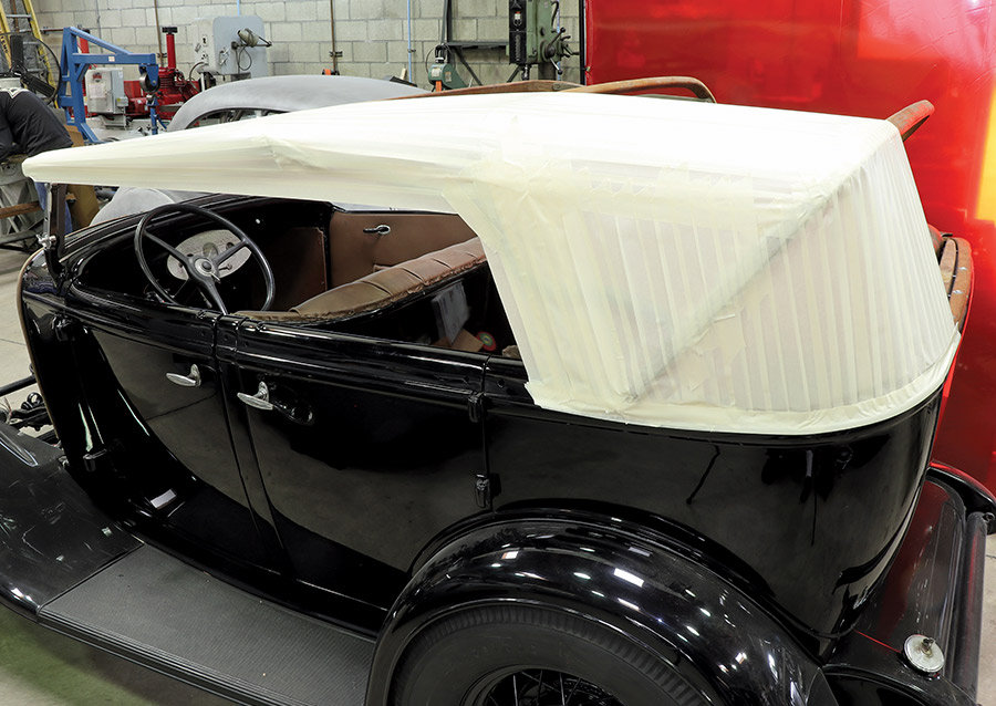 1932 Ford Phaeton displayed at indoor show with tan canvas custom top and snap detailing