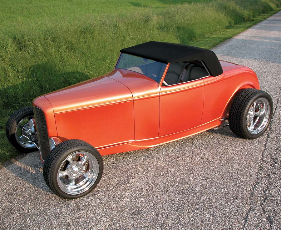1932 Ford Highboy Roadster in copper pearl with black cloth top and billet wheels, parked roadside
