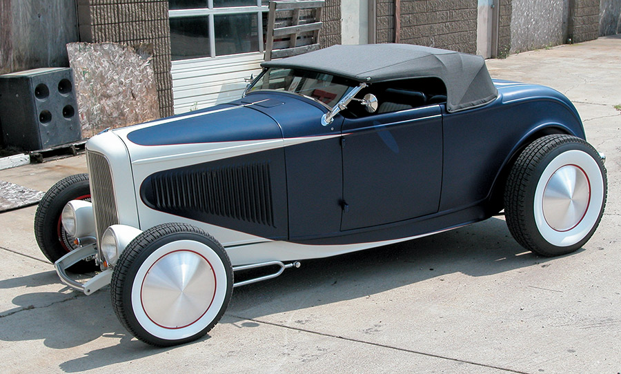1932 Ford Roadster in two-tone navy and pearl with custom hubcaps and gray convertible top