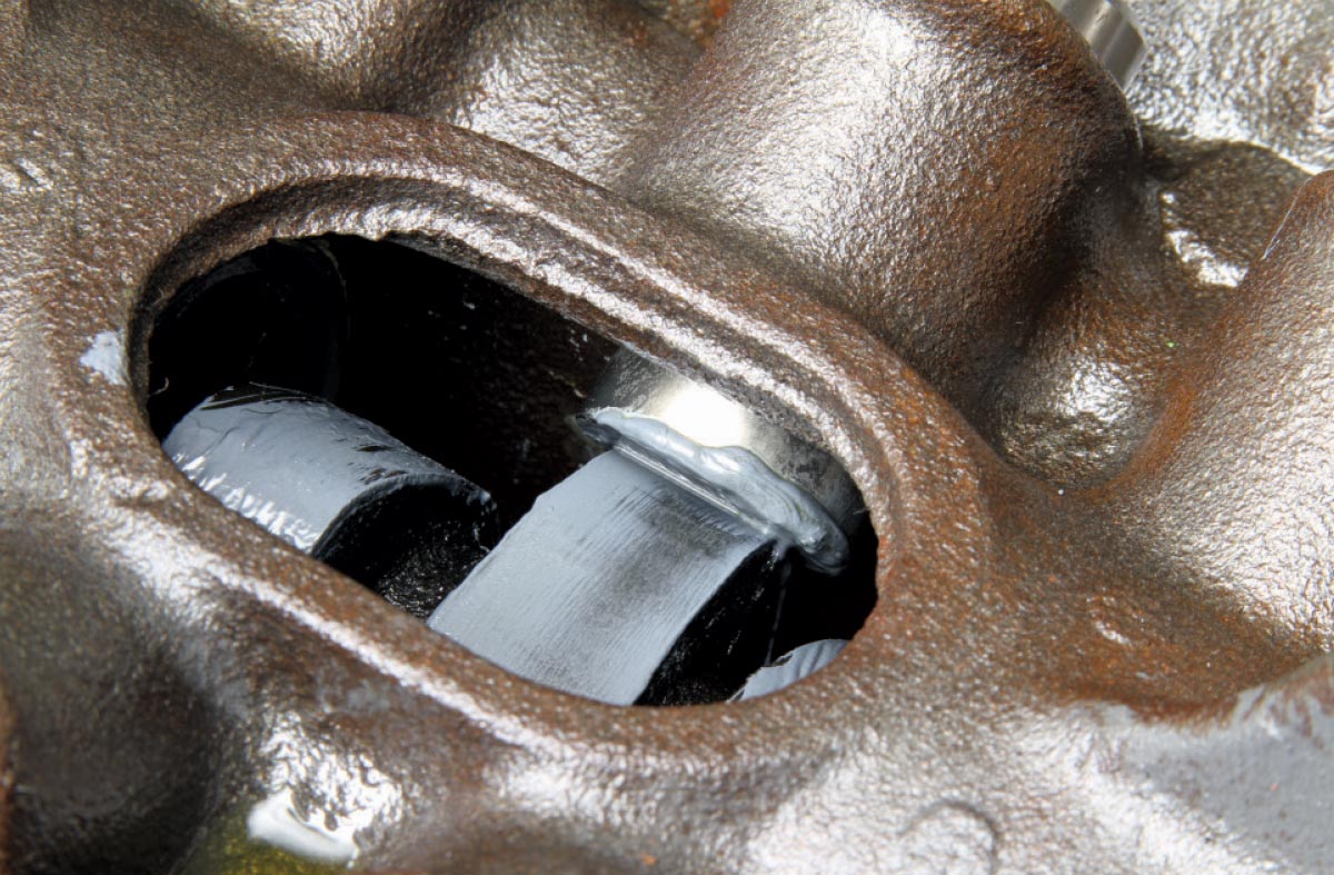 View through lifter bore shows camshaft lobe and journal lubrication on 340 block