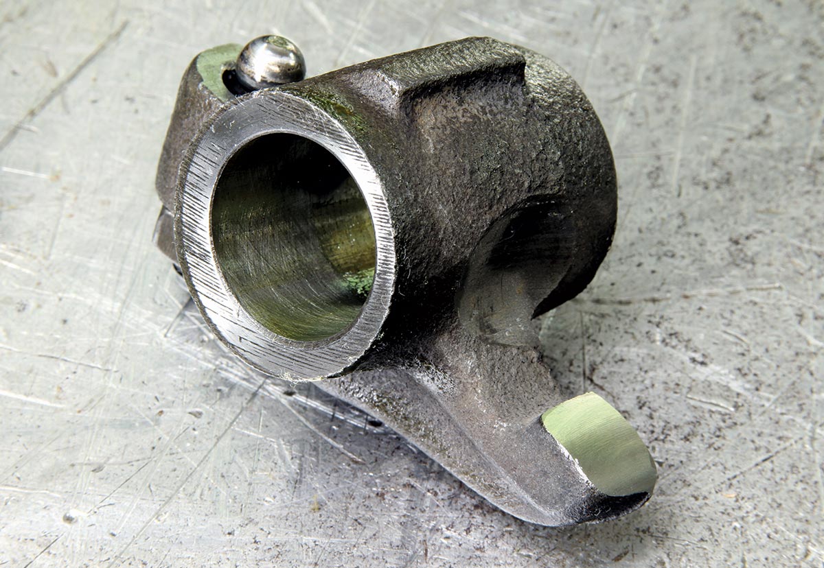 Individual Mopar small-block rocker arm shows wear pattern and oil feed groove