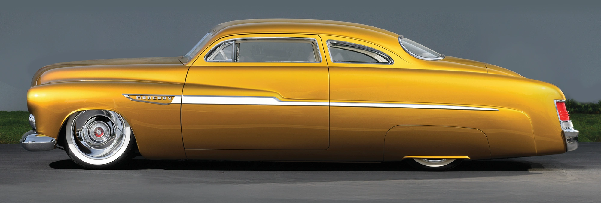 1951 Mercury Custom in metallic gold with chopped roof and full fender skirts