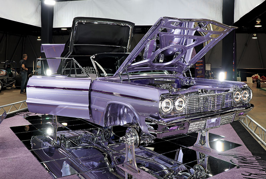 lavender-colored 1964 Buick Riviera on display with all the doors open