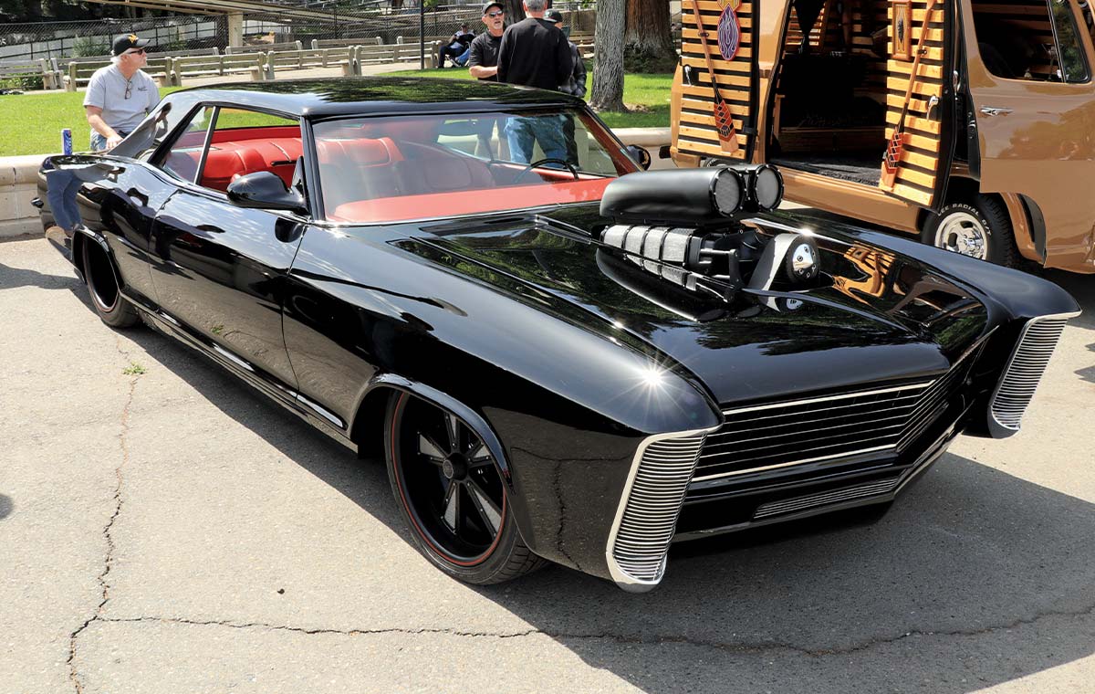 black 1965 Buick Riviera with red seats