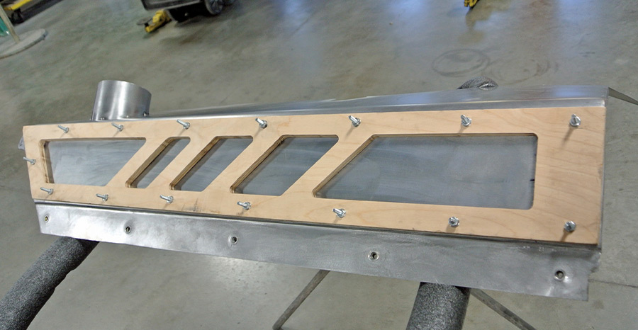 Custom cowl vent panel mock-up for 1971 Plymouth Duster using a wood template and aluminum base