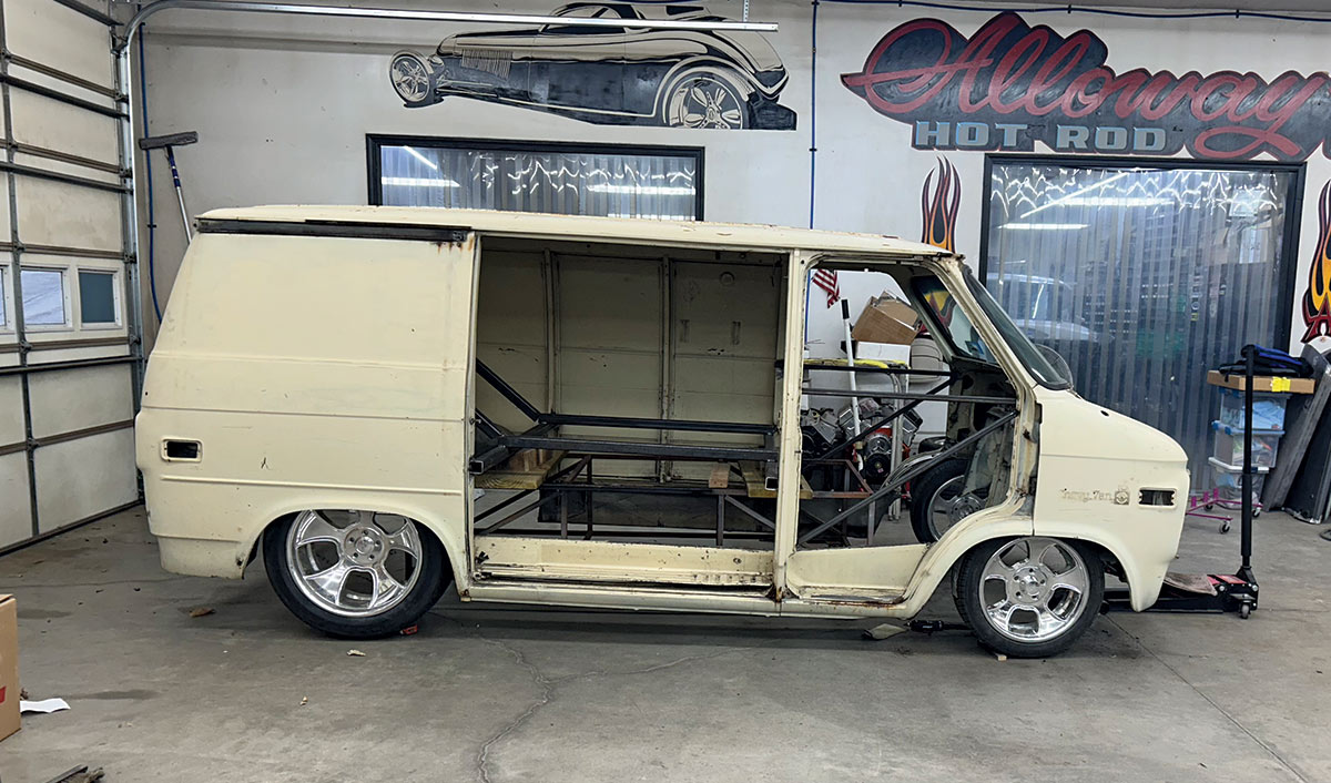 side view of a white 1979 Chevy van with sliding door open