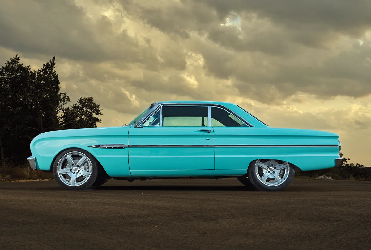 1963 Ford Falcon in turquoise with chrome trim and custom 5-spoke wheels
