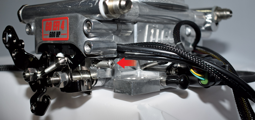 Rear view of polished FiTech Go EFI 4 showing dual fuel inlet ports and throttle linkage