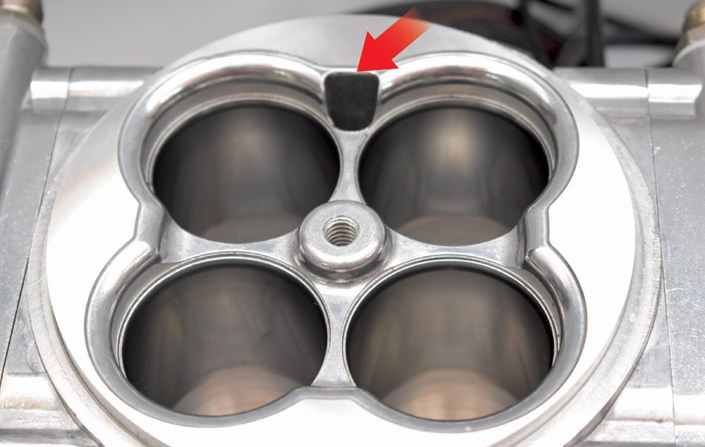 Top view of polished EFI throttle body revealing four venturis with smooth bore finish