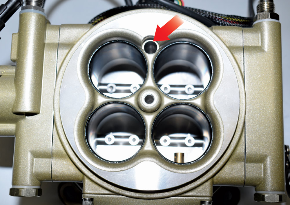 Top view of gold FiTech throttle body showing injectors inside venturis for atomization