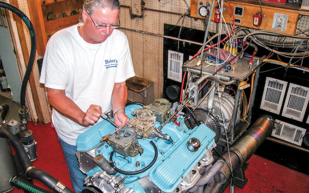 Mechanic tunes the linkage and set up the trio of carbs