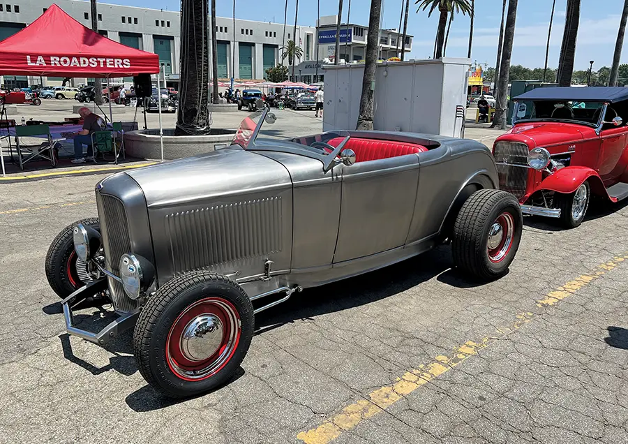 1932 Ford roadster bare metal body with red steelies and whitewall tires