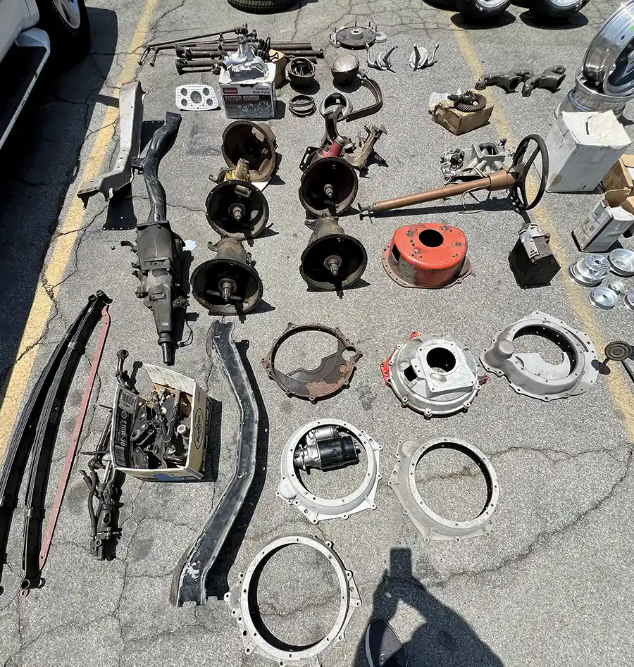 Vintage hot rod parts swap meet layout with transmissions, bellhousings, and suspension components