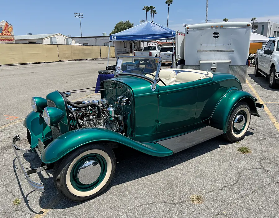 1931 Ford roadster in metallic green with whitewalls and triple-deuce flathead