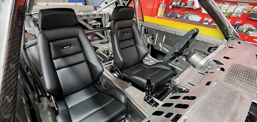 1969 Camaro Recaro interior seats with visible cage and battery relocation