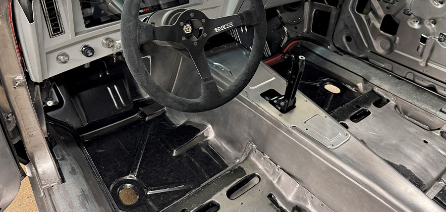 1969 Camaro dash layout Sparco wheel with digital display and raw interior panels