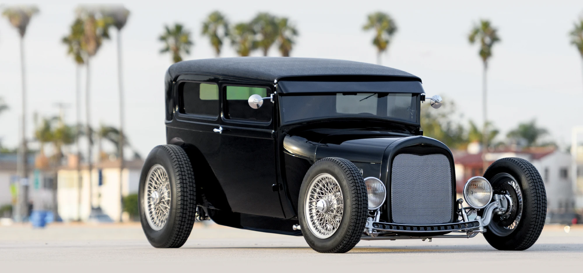 1929 Ford Tudor hot rod with chopped roof, black paint, and chrome knock-off wire wheels